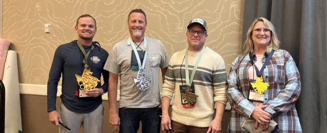 (from left to right) Steven Wayne, Mark Peterson, Mike Boatman and Julie Jacobs wearing their 3D-printed medals for first through fourth place, respectively.