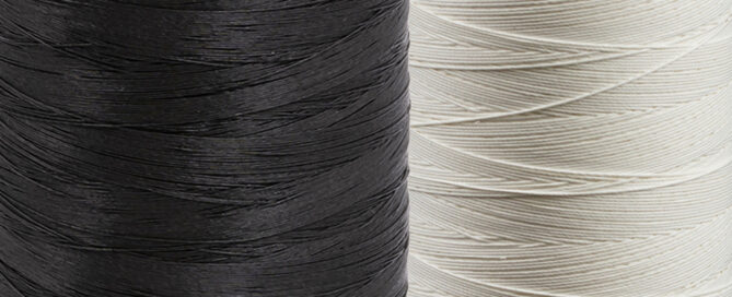 A black spool and a white spool of GORE® TENARA®.