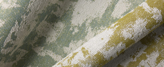 Textured fabric featuring a blend of soft green, white and yellow hues, showcasing a subtle, abstract pattern.