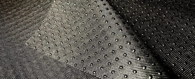 Textured black marine fabric showcasing a woven pattern with raised dots.
